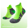 A pair of fluorescent green performance sports ankle socks with dark gray accents.