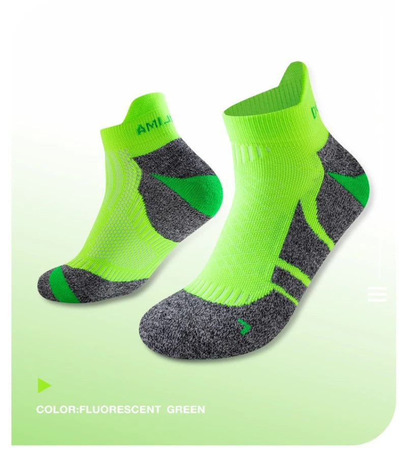 A pair of fluorescent green performance sports ankle socks with dark gray accents.
