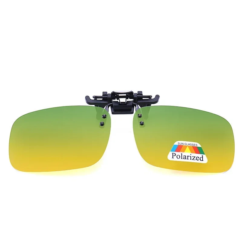 A pair of black sunglasses with yellow-green lenses and a polarized label on the inside.