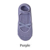 A pair of purple crisscross strap yoga socks.