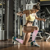 A woman wearing yellow athletic wear is performing a workout exercise while using compression socks.