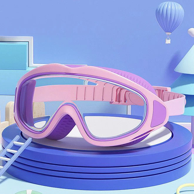 Pink swimming goggles for children resting on a blue circular platform with a light blue background and a purple balloon.