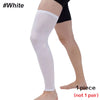 A white full leg compression sleeve worn on a person's leg.