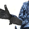 A person wearing black motorcycle riding gloves is holding their hand out, showing the textured palm.