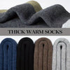 A close-up of thick warm socks in various colors including navy blue, black, brown, and gray.