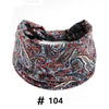 A close-up of a patterned blue and red boho print cotton headband.