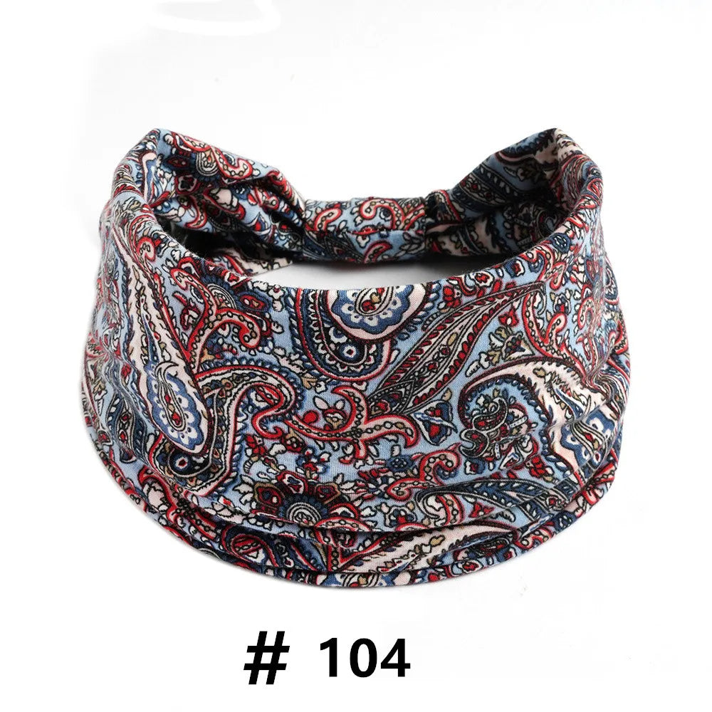 A close-up of a patterned blue and red boho print cotton headband.