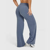 A model is wearing dark blue high-waist yoga pants while standing.