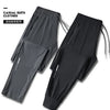 A pair of black casual suit clothes or sports pants shown flat, featuring zippered pockets.