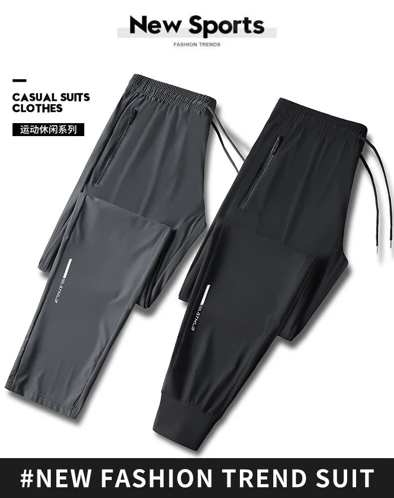 A pair of black casual suit clothes or sports pants shown flat, featuring zippered pockets.