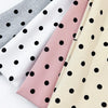 A set of four polka dot elastic hair bands in shades of gray, pink, and cream.