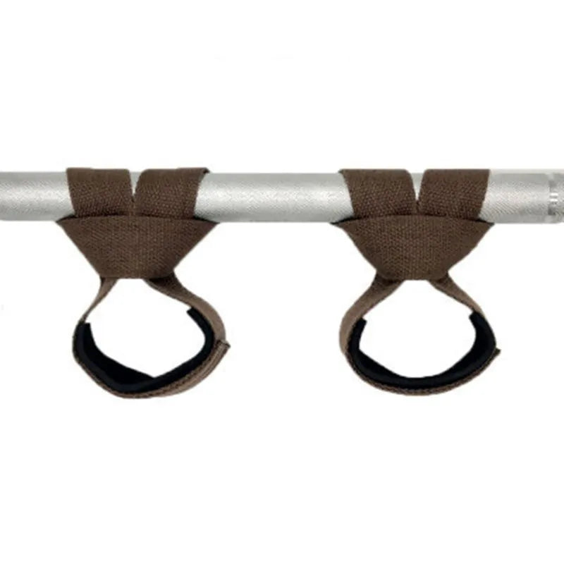 A pair of brown gym lifting straps with wrist supports mounted on a silver bar.