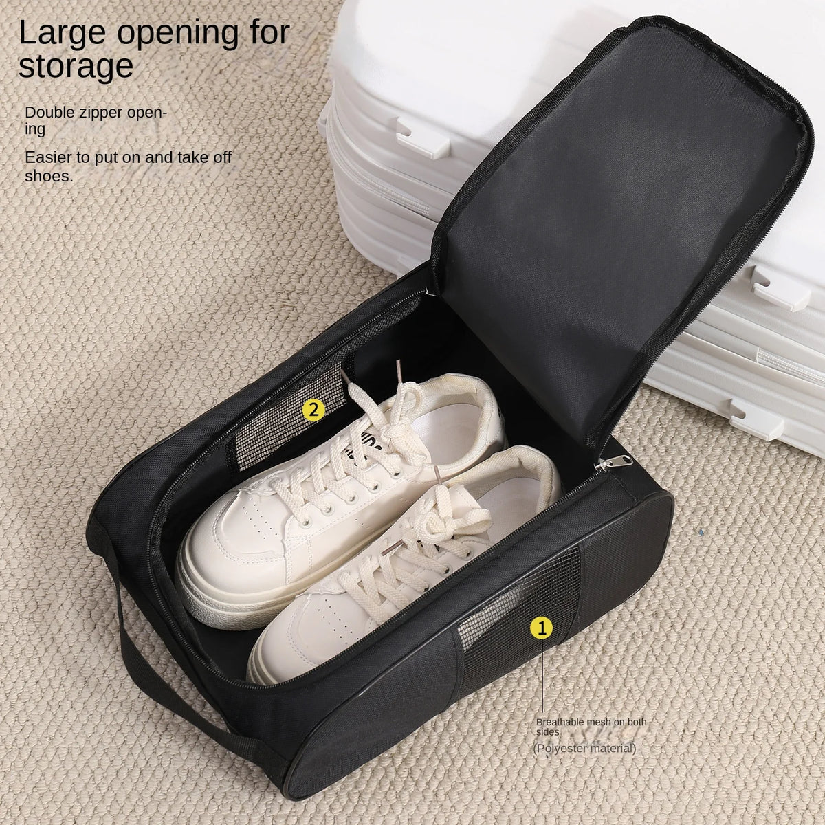 Black shoe carrier bag with a double zipper opening showing a pair of white leather shoes inside