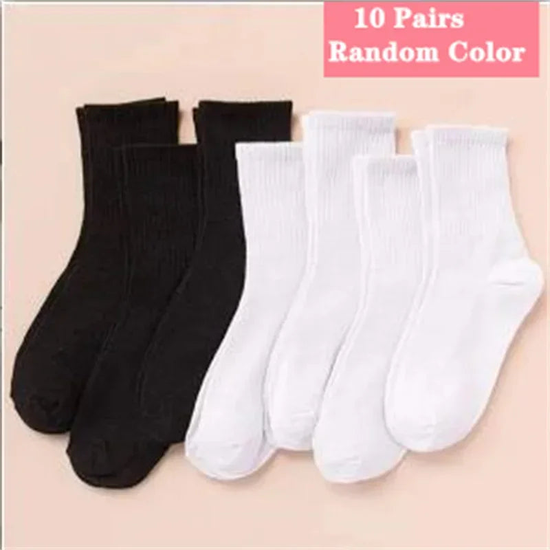 Ten pairs of random colored socks, including black and white, displayed flat.