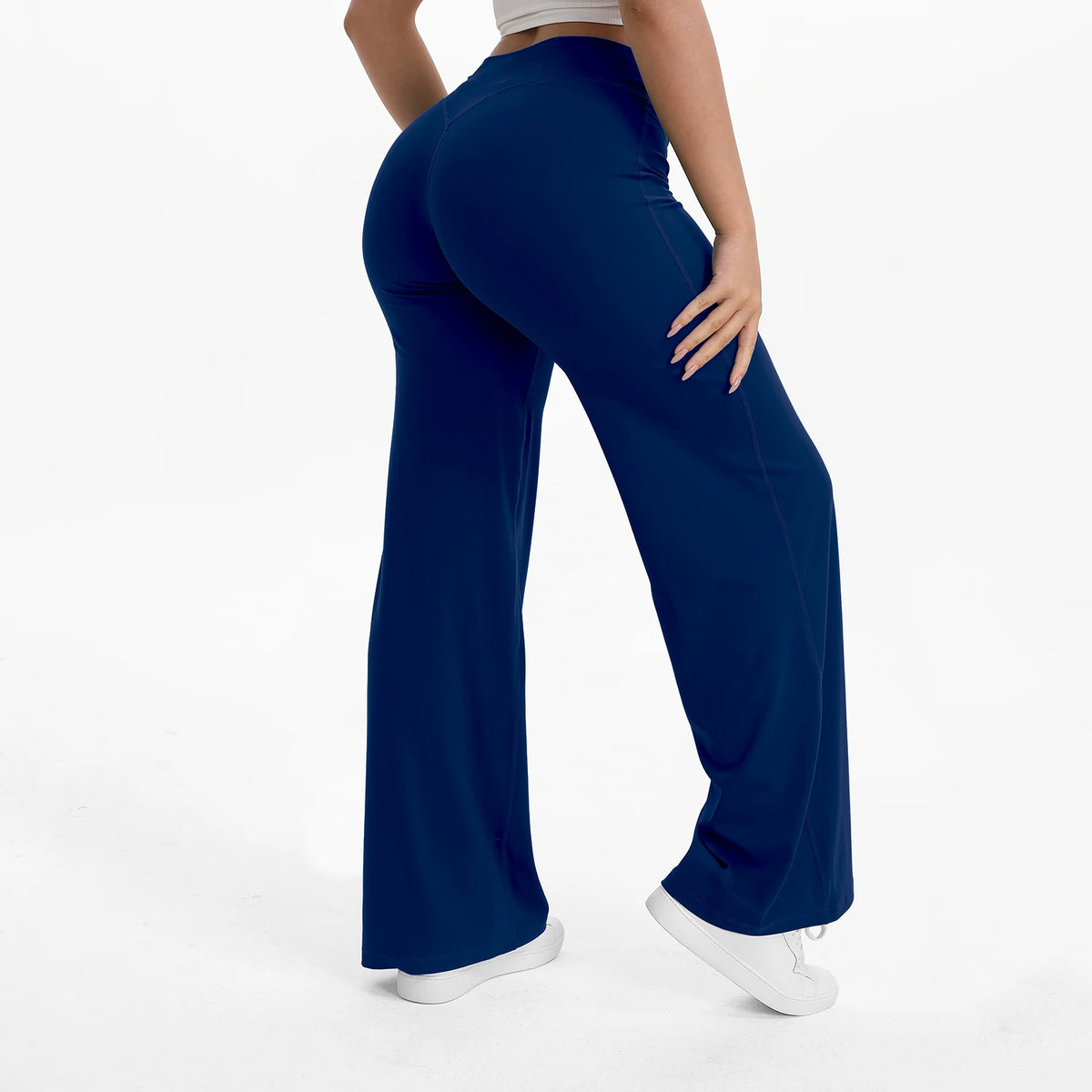 A person wearing navy blue NCLAGEN SoftMotion straight leg yoga pants and a light top.