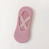 A single pink non-slip yoga and gym sock with a silicone grip pattern.