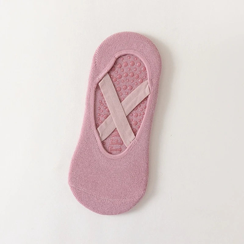 A single pink non-slip yoga and gym sock with a silicone grip pattern.