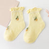A pair of yellow knitted baby socks with small olive-green designs displayed on a white background.