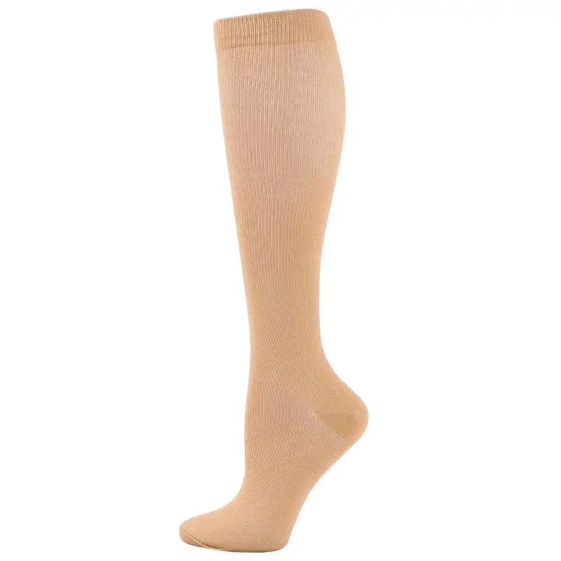 A beige compression sock for veins and pregnancy, shown standing upright.