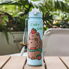 A light blue cartoon drinking water bottle with a strawberry bear design sitting on a wooden surface.