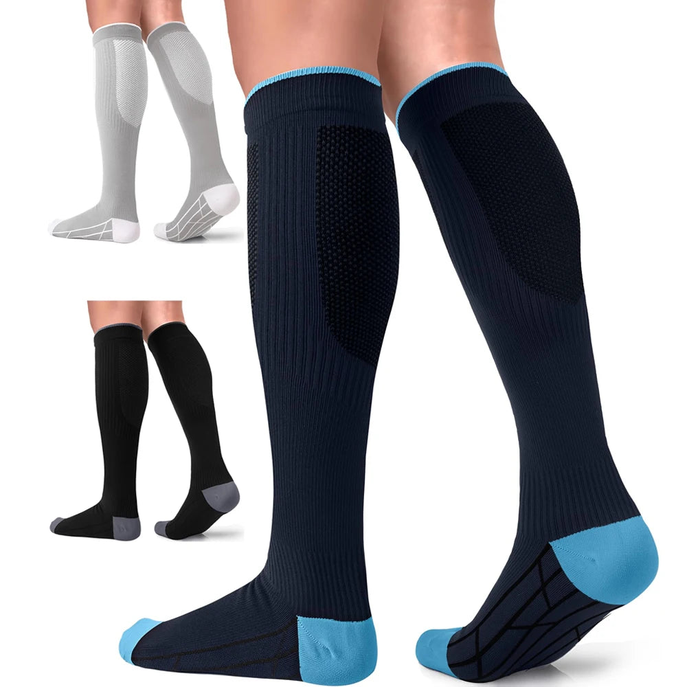 A pair of navy blue compression socks with light blue accents shown on a foot and leg.