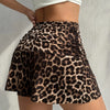 A model wearing a brown and black leopard print casual skirt with a white crop top.