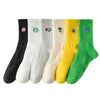 A set of five men's athletic embroidered crew socks in black, white, cream, yellow, and green.