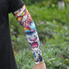 Close-up of a person's arm displaying colorful ice silk tattoo sleeves with vibrant designs.