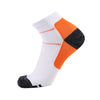 A pair of white compression socks with orange and black accents, shown from the side.