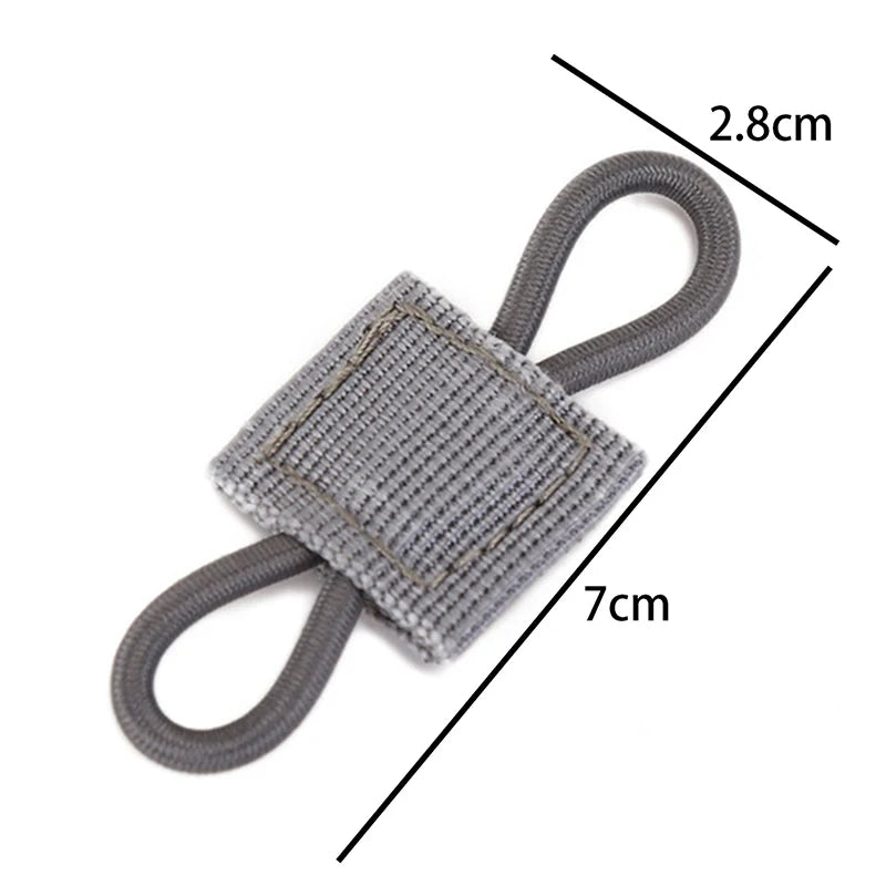 A gray tactical antenna binding buckle with a woven fabric strap and loop, shown with dimension lines.