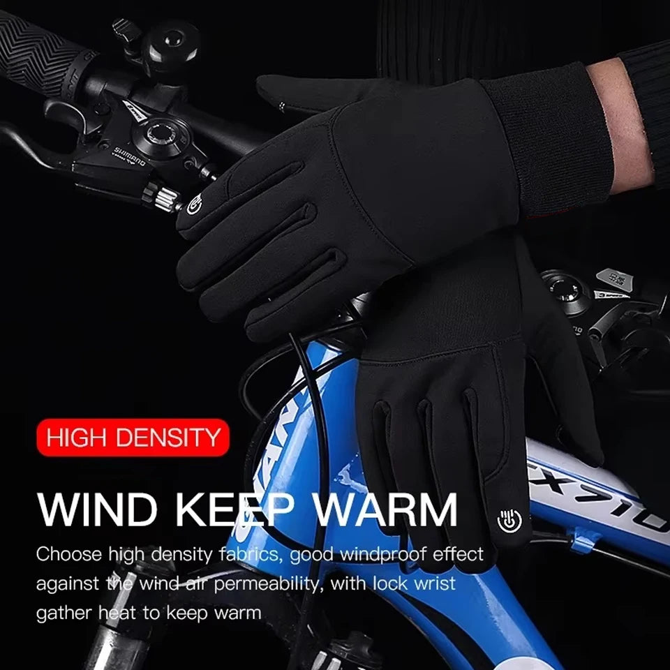 Black high-density cycling gloves being worn on a hand, with a blue bicycle visible in the background.