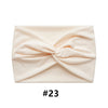 A light pink, ruched fabric headband is shown folded, labeled #23.