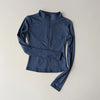 A navy blue long-sleeved zip-up jacket for yoga and fitness.
