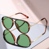 Pair of brown tortoiseshell gradient aviator sunglasses resting on a light surface.
