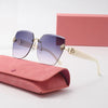 Light luxury frameless sunglasses with gold accents resting on a pink velvet pouch and a pink box.