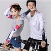 A woman and a man modeling a pair of purple and white cooling UV protection arm sleeves.