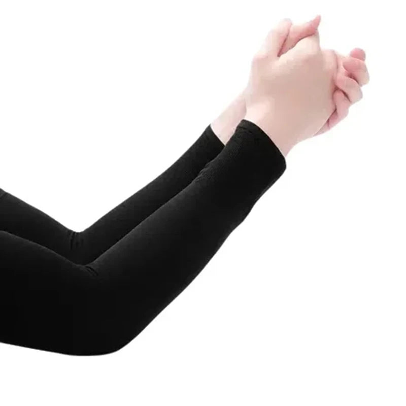 A person wearing black summer cycling arm sleeves is shown with their hands together.