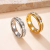 A pair of gold and silver statement rings featuring CZ gemstones displayed on a light background.