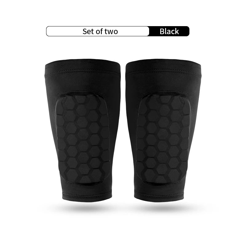 A set of two black honeycomb shin guards for football training.