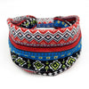 A colorful bohemian stretch cotton headband featuring geometric patterns in red, black, and blue stripes.