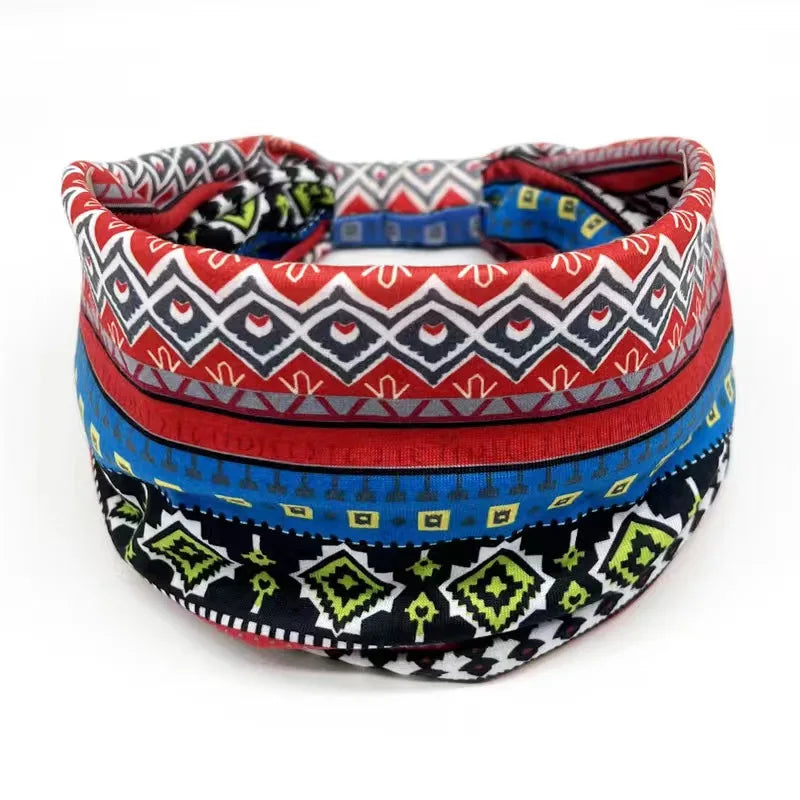 A colorful bohemian stretch cotton headband featuring geometric patterns in red, black, and blue stripes.
