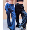 A pair of women's loose sports yoga pants in dark blue and black fabric shown on a model.
