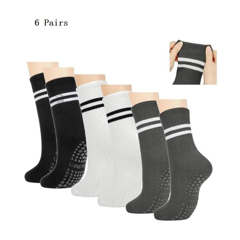 Six pairs of black and white grip socks for Pilates, yoga, and barre