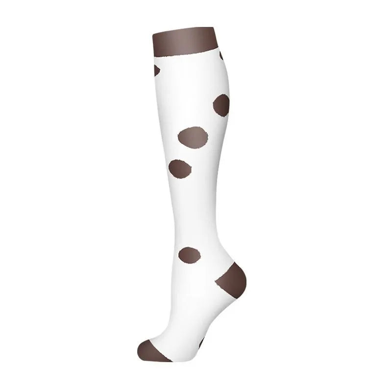 A pair of white compression socks with brown polka dots.