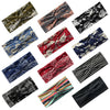 A collection of various patterned silk ties and scarves featuring bohemian vintage prints in floral and abstract designs.