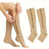 A pair of beige compression stockings with zippers are shown on a person's leg and laid out separately.