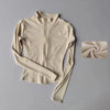 A beige long-sleeved zip-up yoga and fitness jacket displayed flat with a rolled fabric swatch.