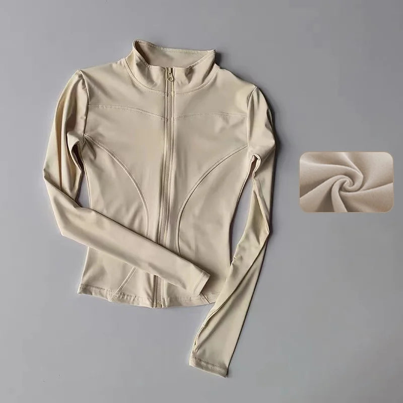 A beige long-sleeved zip-up yoga and fitness jacket displayed flat with a rolled fabric swatch.
