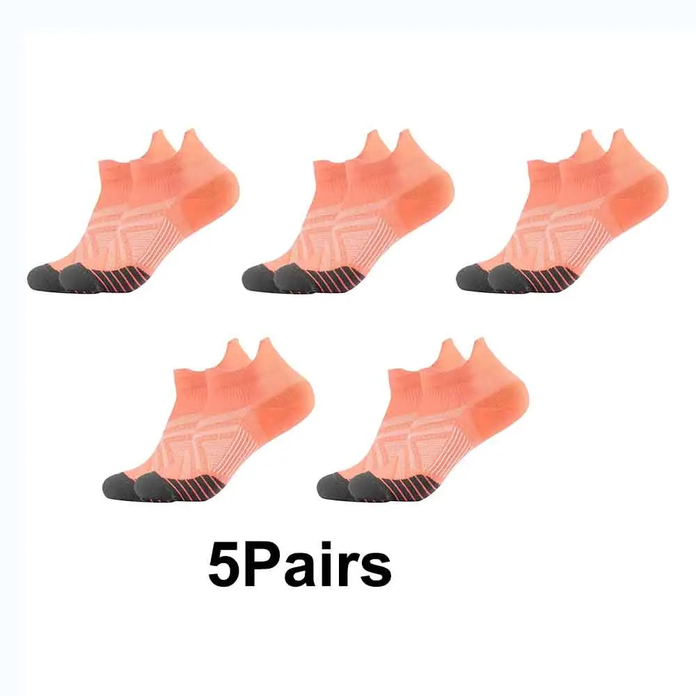Five pairs of coral-colored performance compression sports socks displayed on a white background.