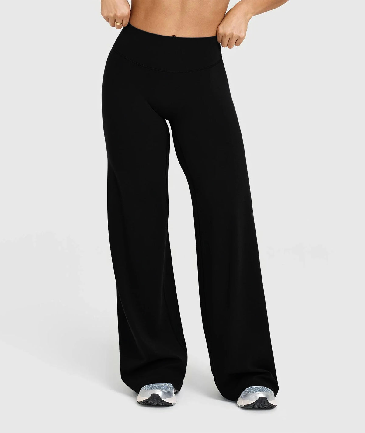 Black high waisted wide leg yoga pants worn by a person.